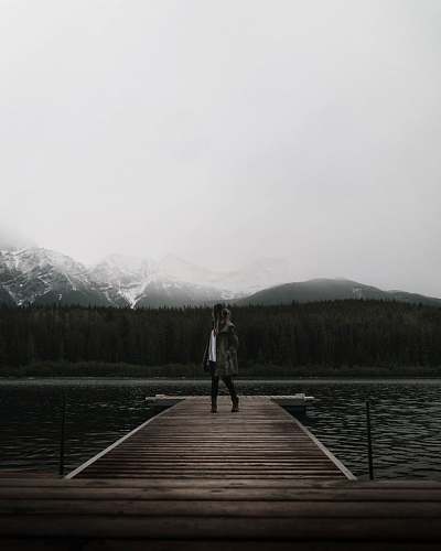 canada person standing on brown dock sports